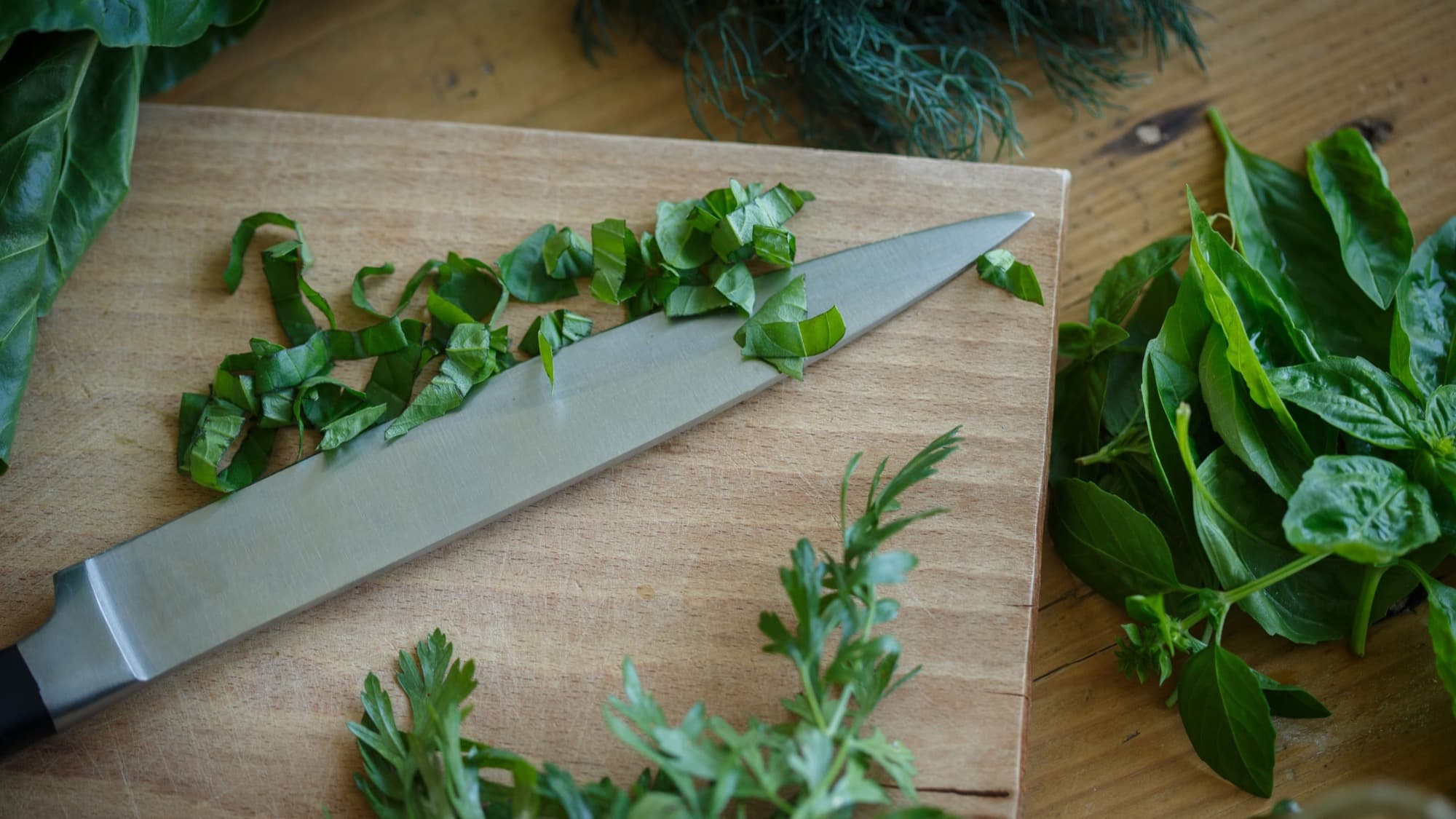 Fresh Beginner’s Kitchen herbs being used in everyday cooking.