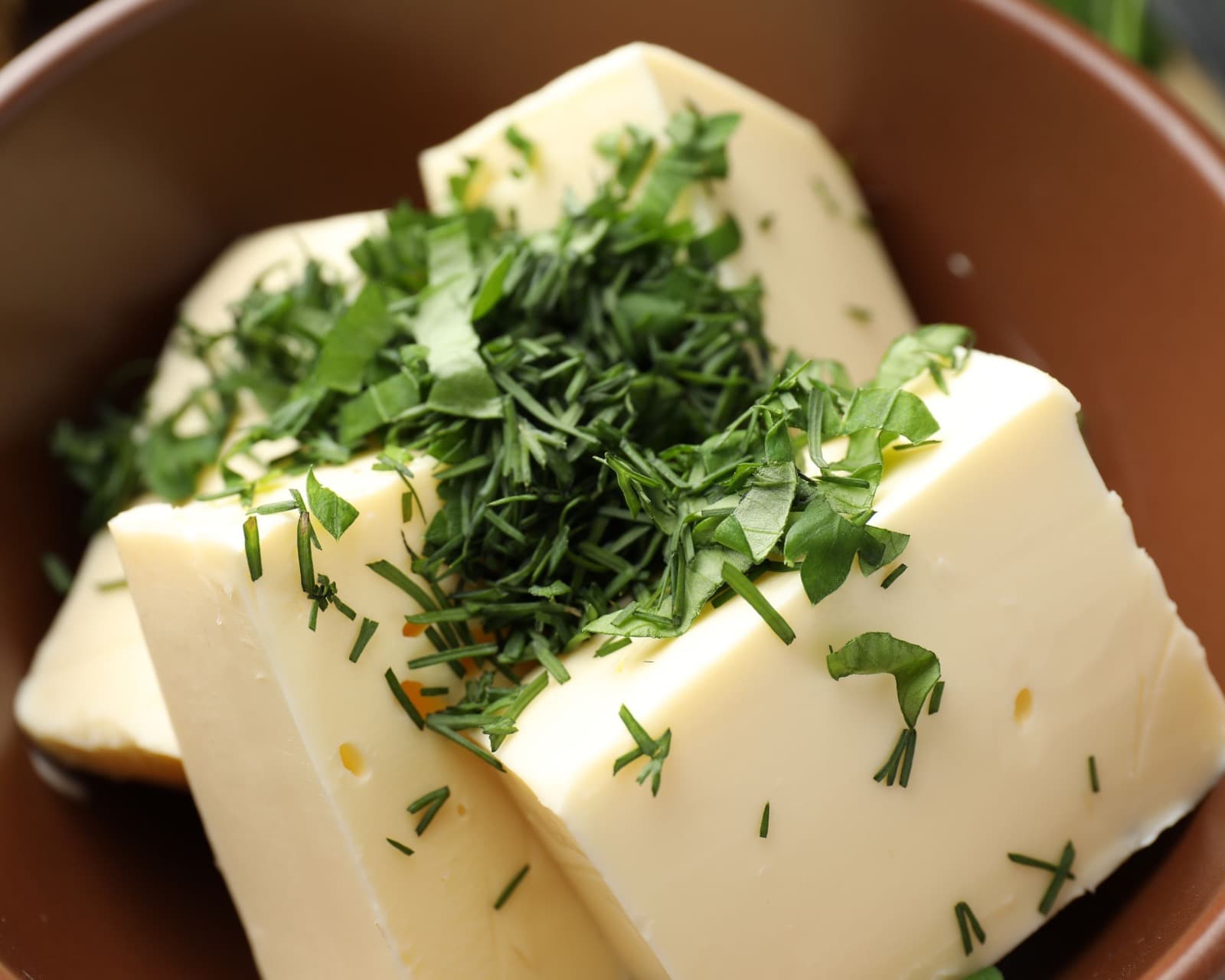 Prepared fresh herb butter with visible chopped herbs.